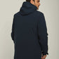 Man wearing dark blue hooded jacket and blue jeans, back view, against plain background