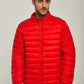 Man wearing a bright red puffer jacket with zip front and blue jeans on a neutral background