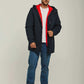 Man wearing a navy hooded jacket with red lining, white t-shirt, blue jeans, and sneakers