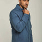 Man wearing a blue casual jacket with stand collar and front pockets