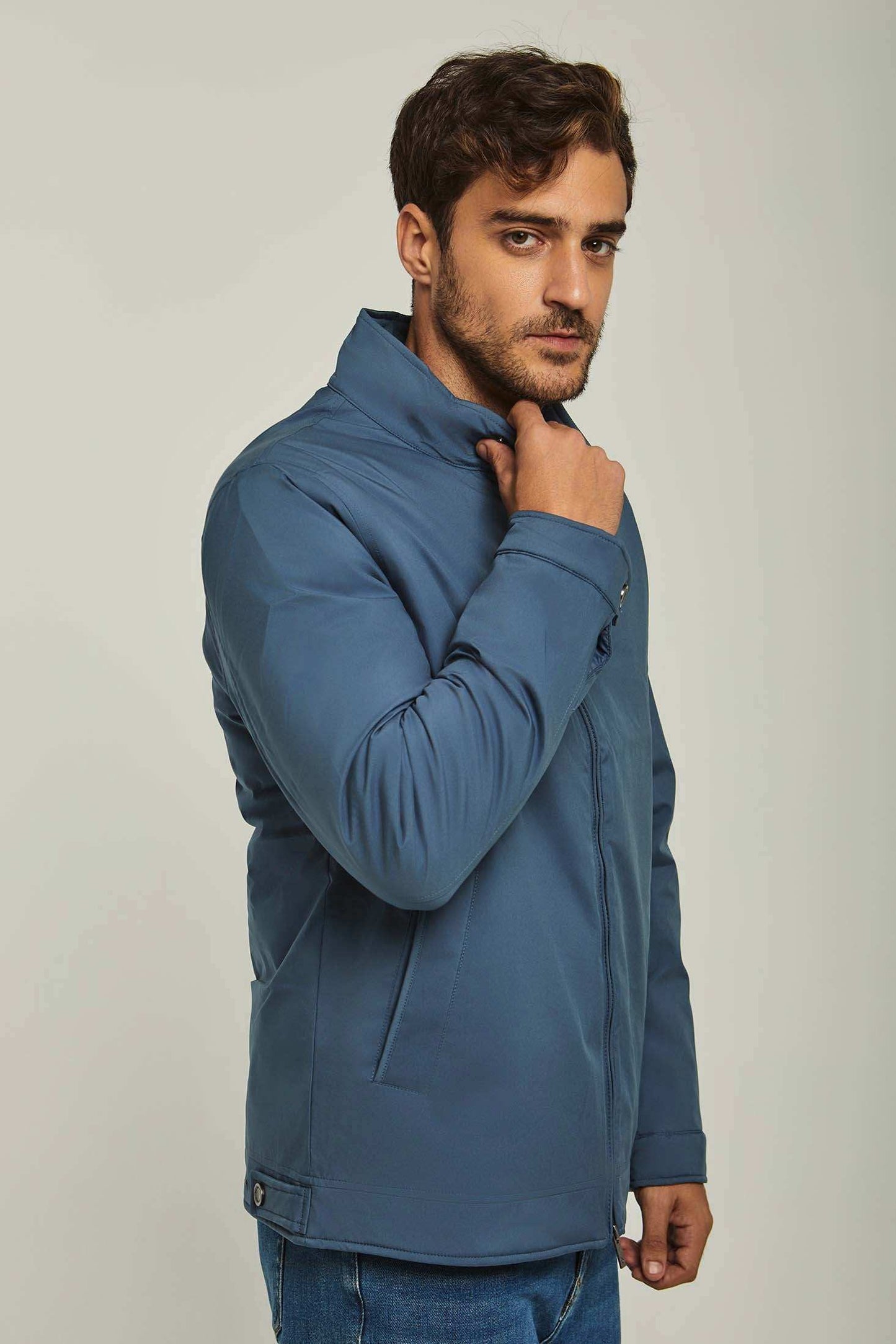 Man wearing a blue casual jacket with stand collar and front pockets