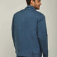 Man wearing a blue casual jacket and blue jeans, back view, neutral background