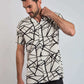 Man wearing a short sleeve white shirt with bold black geometric pattern, casual style