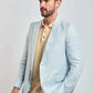Man wearing Dalydress light blue suit and beige polo shirt, stylish men's fashion