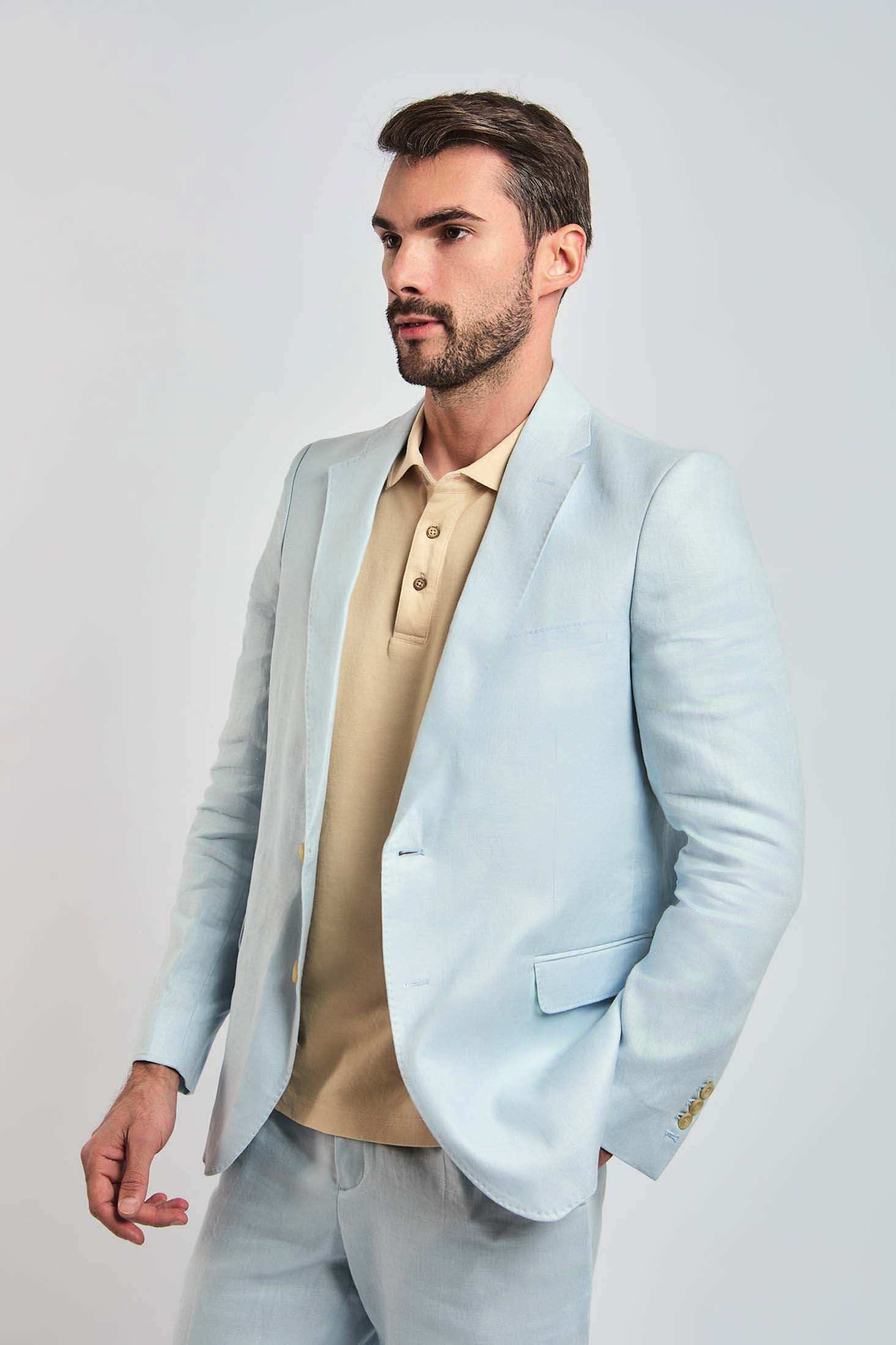 Man wearing Dalydress light blue suit and beige polo shirt, stylish men's fashion