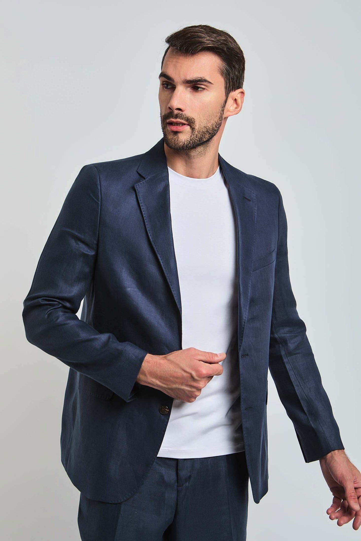 Man in a navy Dalydress suit jacket and white shirt, stylish men's fashion, Egyptian brand