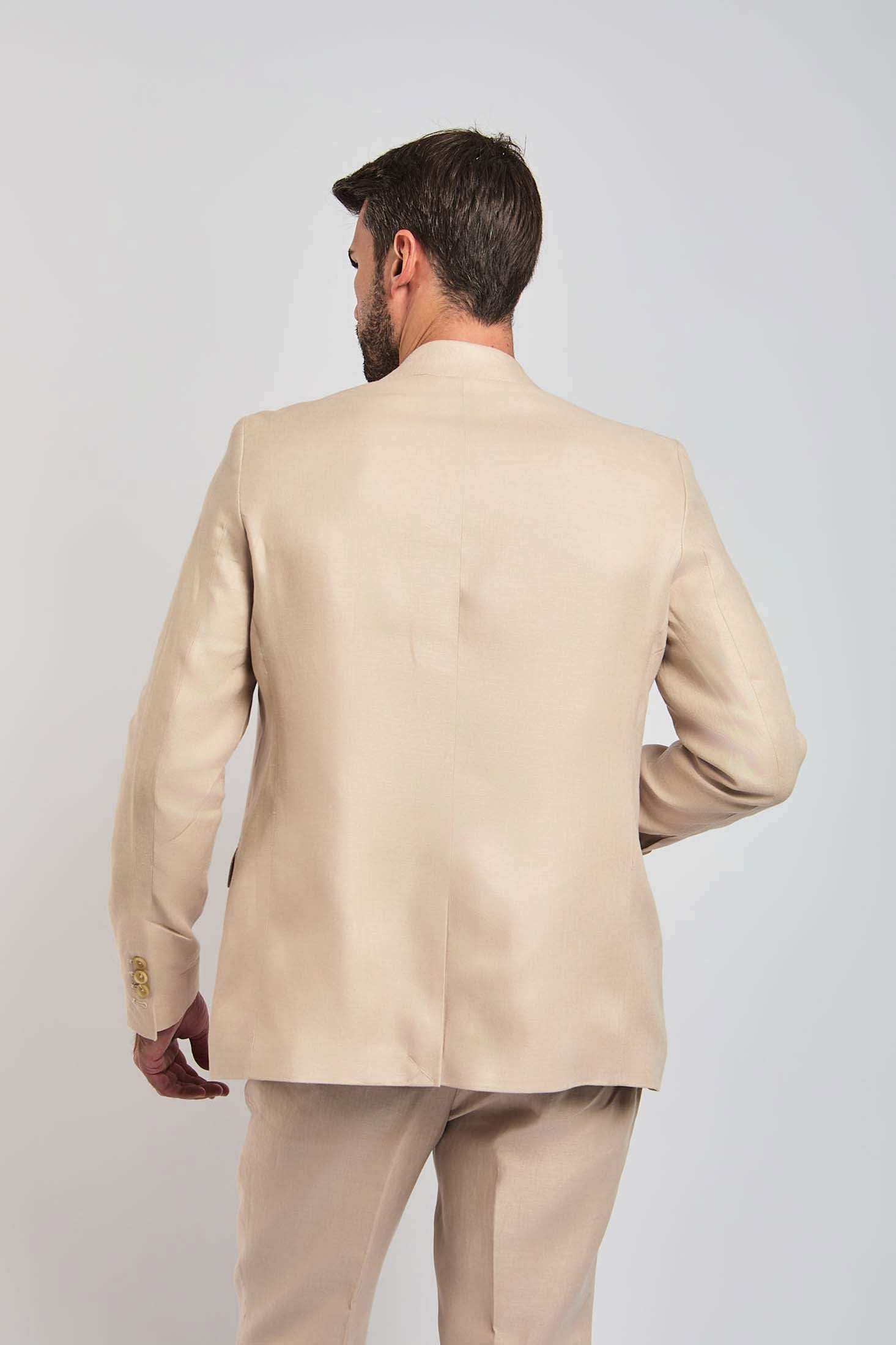Back view of a man wearing a beige Dalydress suit, showcasing men's formal wear style.