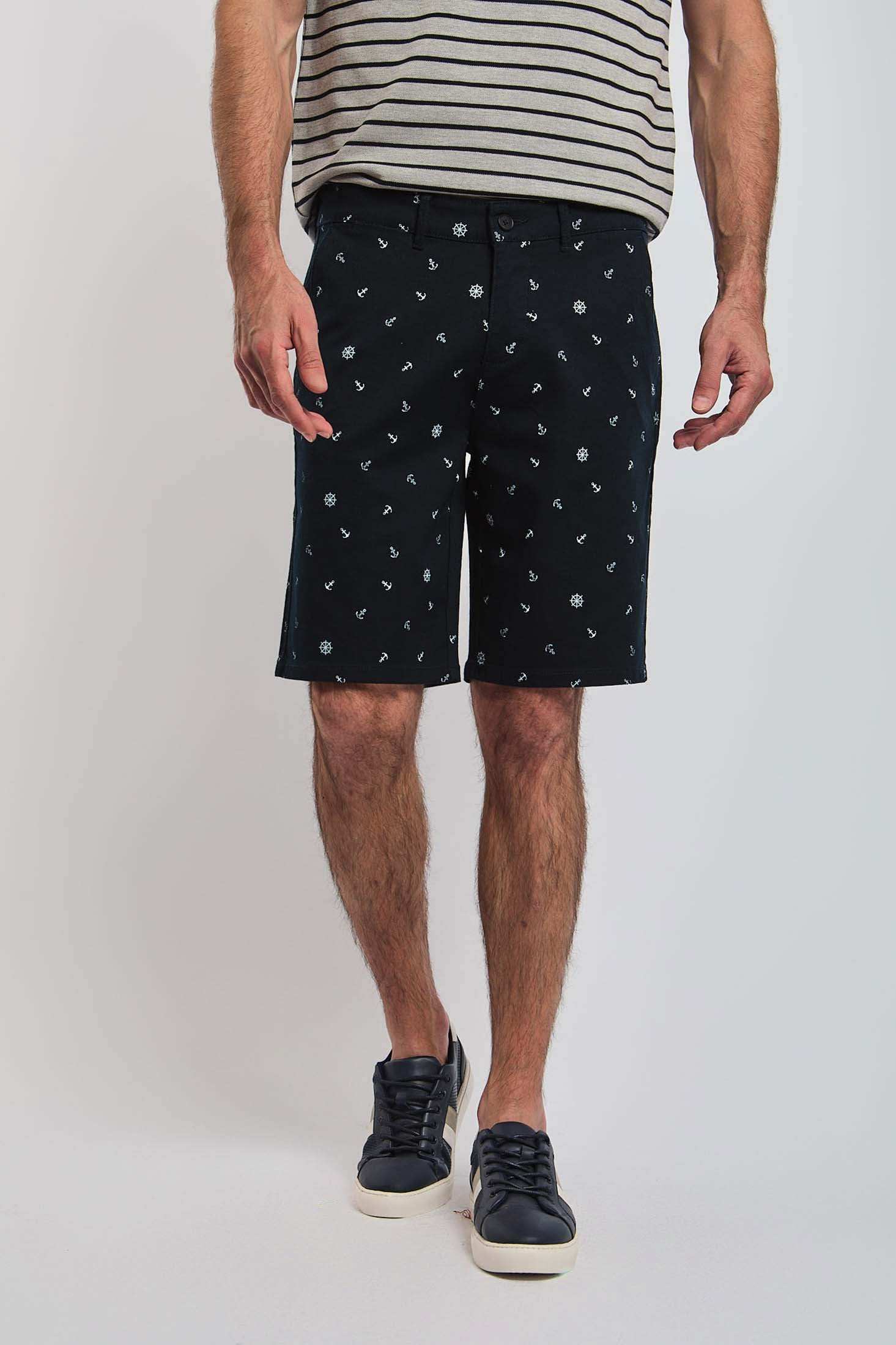Dalydress men’s navy shorts with white nautical prints, striped shirt, and black sneakers