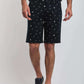 Dalydress men’s navy shorts with white nautical prints, striped shirt, and black sneakers