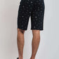 Dalydress men's black printed shorts, back view, paired with striped t-shirt and sneakers