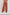 Back view of woman wearing wide leg rust orange embroidered pants with eyelet details