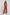 Woman wearing rust orange embroidered pantsuit with wide-leg trousers and long-sleeve top