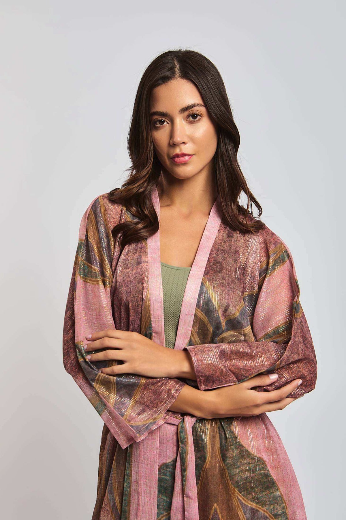 Woman wearing a pink and brown floral kimono-style dress with long sleeves