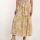 Woman wearing Dalydress yellow floral maxi skirt with tie belt and lilac top