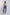 Woman wearing beige top, embroidered cream jacket, blue pants, and heels, Dalydress fashion.