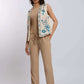 Woman wearing beige pants, tan top, and embroidered vest from Dalydress, standing in studio