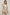 Woman wearing beige linen blazer and pants set from Dalydress against neutral background