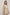 Woman wearing beige linen blazer and pants from Dalydress against plain background