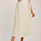Woman wearing Dalydress beige tank top and cream pinstripe wrap midi skirt with tie waist
