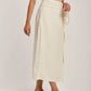 Woman wearing beige sleeveless top and cream striped midi skirt by Dalydress