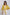 Woman wearing Dalydress yellow tie-front blouse and white studded pants