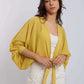Woman wearing yellow tie-front top and white embellished pants, Dalydress fashion collection