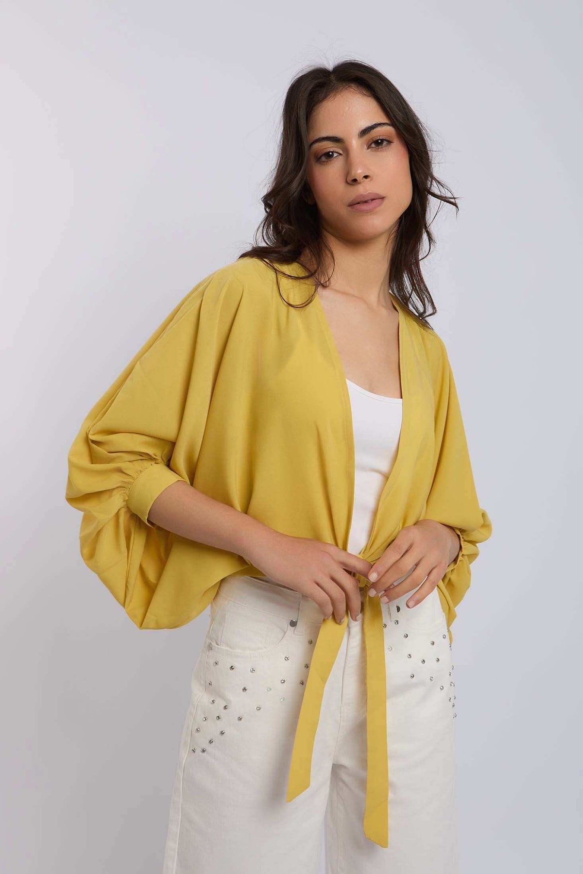 Woman wearing yellow tie-front top and white embellished pants, Dalydress fashion collection