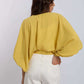 Woman wearing yellow batwing blouse and white wide-leg pants, Dalydress casual fashion
