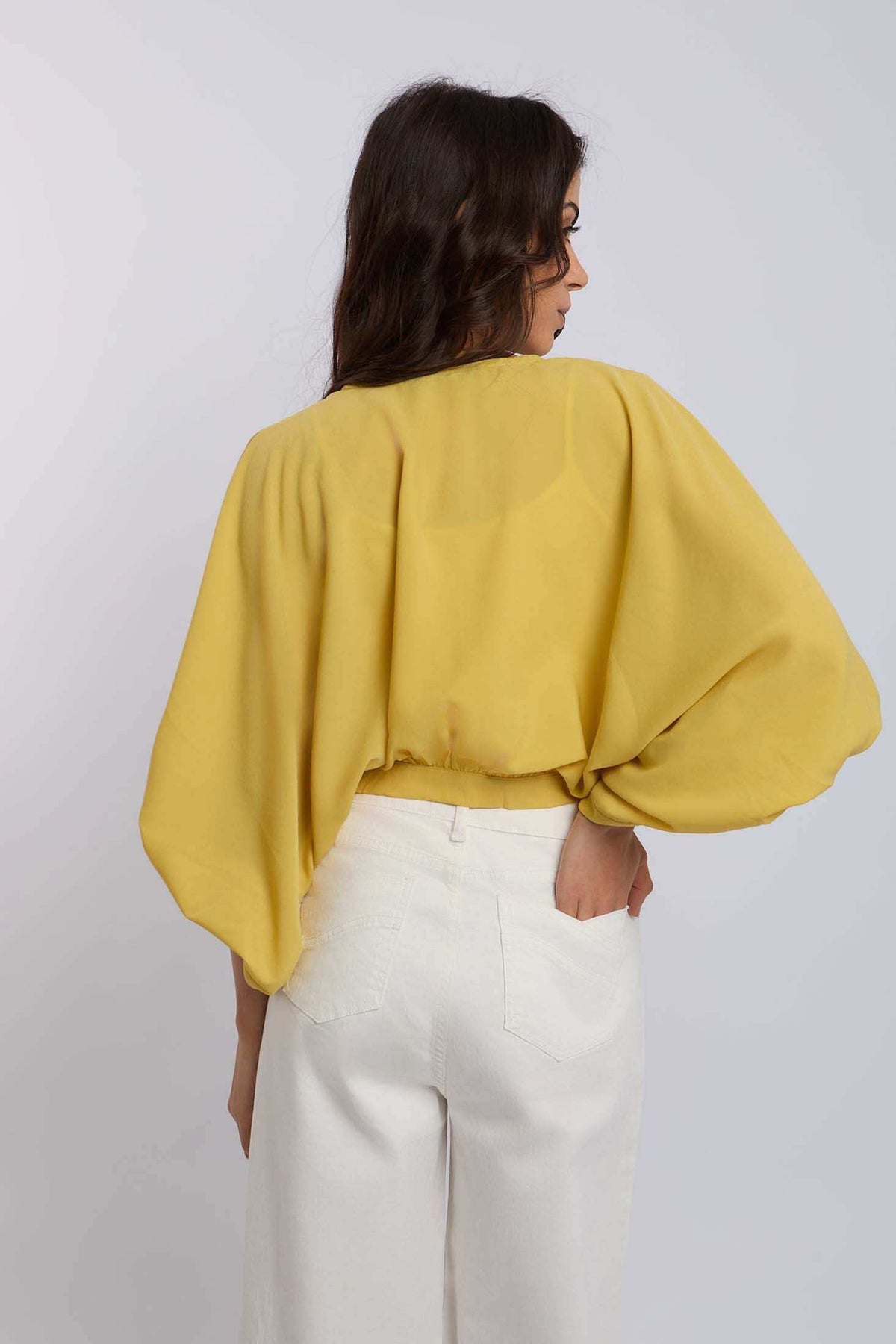 Woman wearing yellow batwing blouse and white wide-leg pants, Dalydress casual fashion