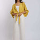 Woman wearing yellow tie-front blouse and white wide-leg pants from Dalydress fashion collection