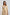 Woman wearing Dalydress cream floral print dress with ruffle detail, fashion studio shot