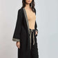 Woman modeling Dalydress black long cardigan with beige geometric trim, casual women's wear