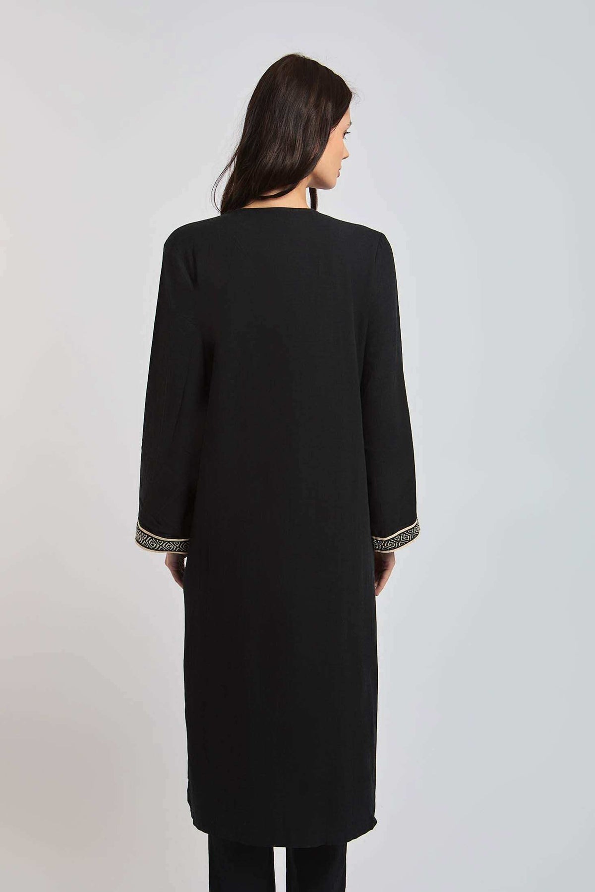Dalydress women's black long-sleeve coat with gold-trimmed cuffs, back view