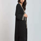 Woman wearing a Dalydress black long cardigan with geometric trim, modern Egyptian fashion