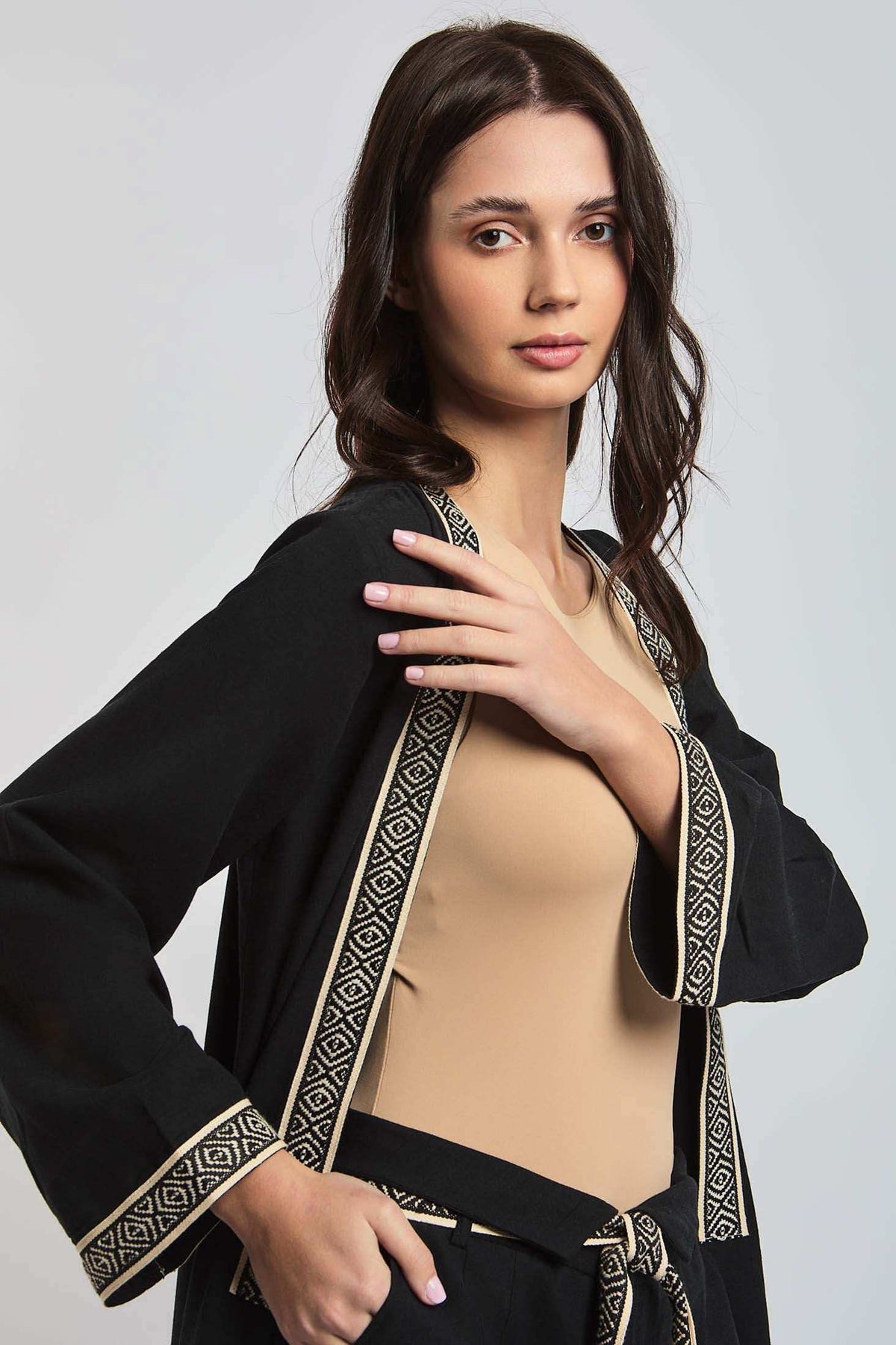Dalydress women's black jacket with geometric trim, beige top, and matching belt