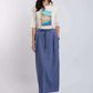 Woman wearing Dalydress casual Amalfi graphic t-shirt and blue maxi skirt, studio background