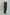 Woman wearing Dalydress olive green wide-leg pants and white blouse, side view
