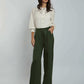 Woman wearing Dalydress white embroidered blouse and green wide leg pants