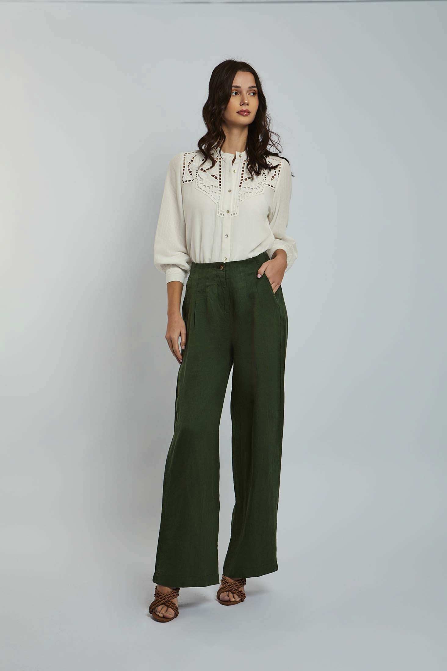Woman wearing Dalydress white embroidered blouse and green wide leg pants