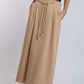 Woman wearing beige maxi skirt with rope belt, navy graphic top, Dalydress casual style