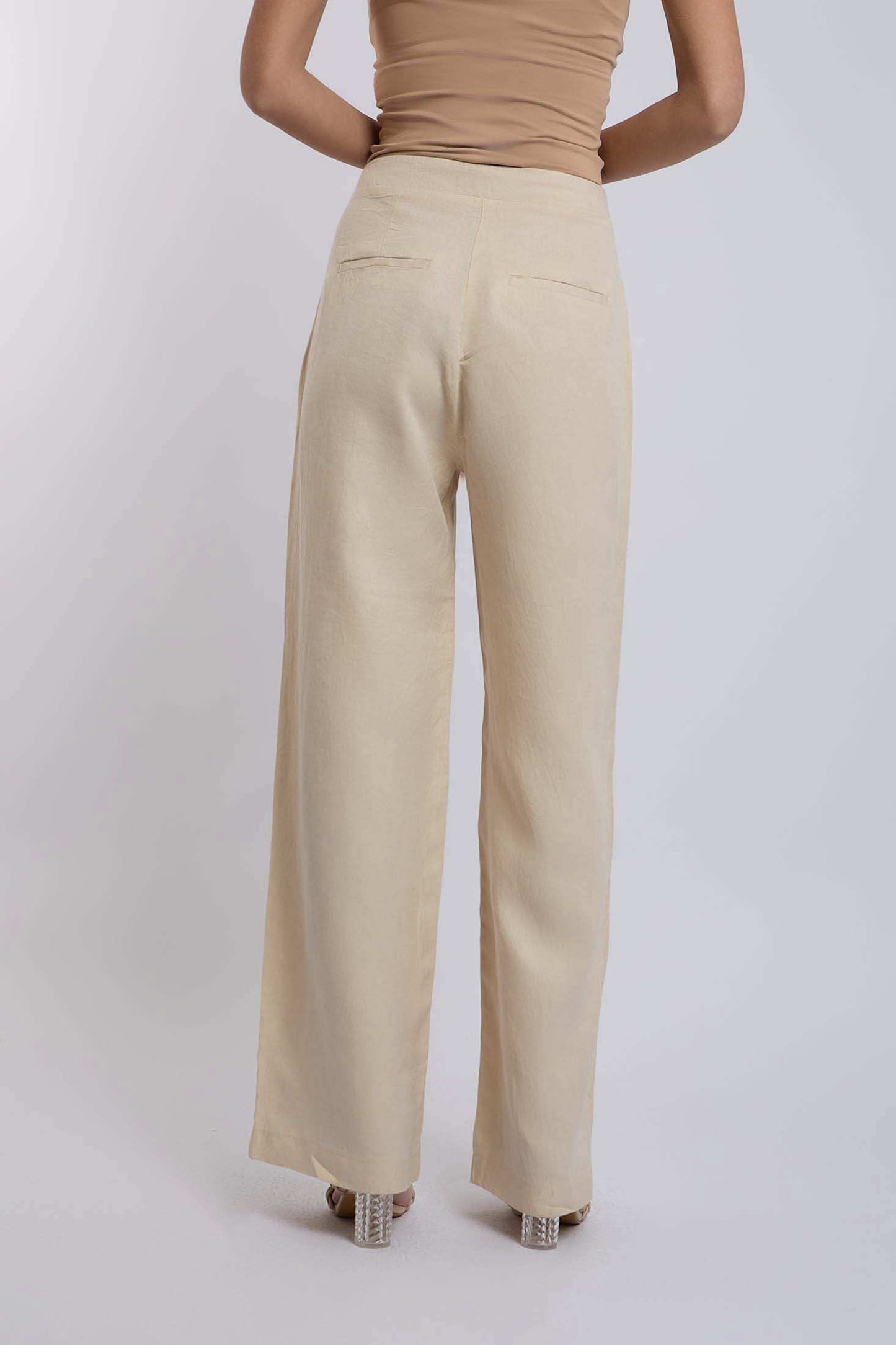 Dalydress women's beige wide-leg pants with back welt pockets, styled on model