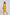 Woman in yellow sleeveless belted dress by Dalydress, standing against white background