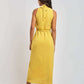 Woman modeling sleeveless yellow midi dress with tie neck, Dalydress Egyptian fashion