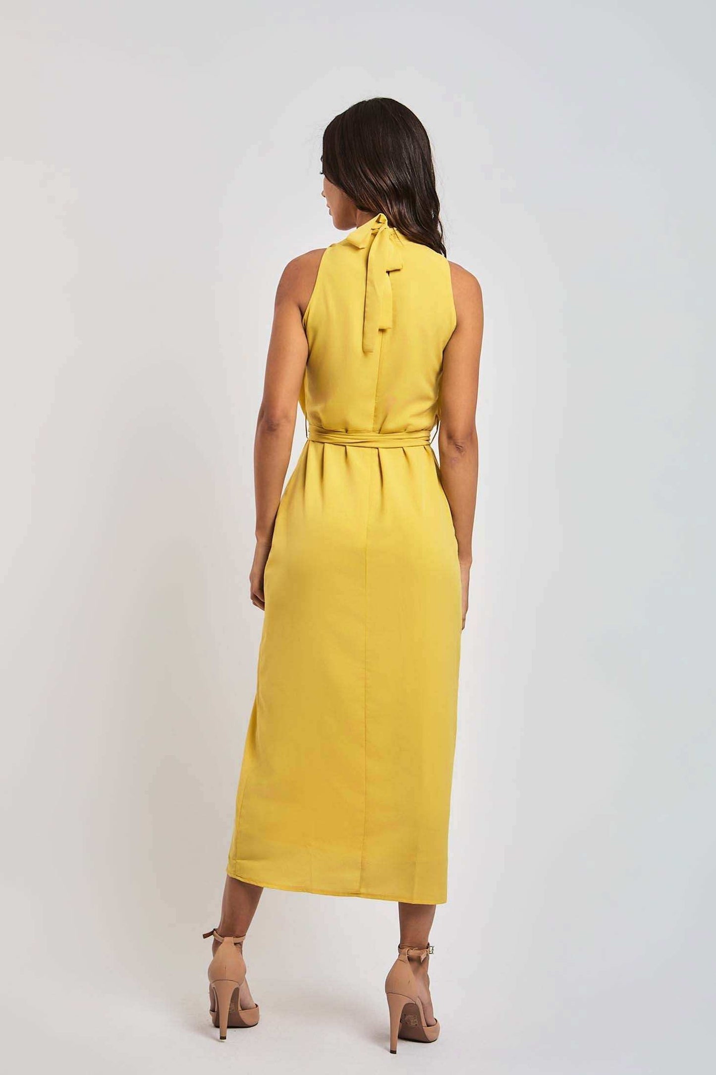 Woman modeling sleeveless yellow midi dress with tie neck, Dalydress Egyptian fashion