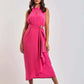 Woman wearing a sleeveless hot pink Dalydress midi dress with waist belt, neutral heels