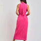Woman in sleeveless pink midi dress from Dalydress, standing with back view