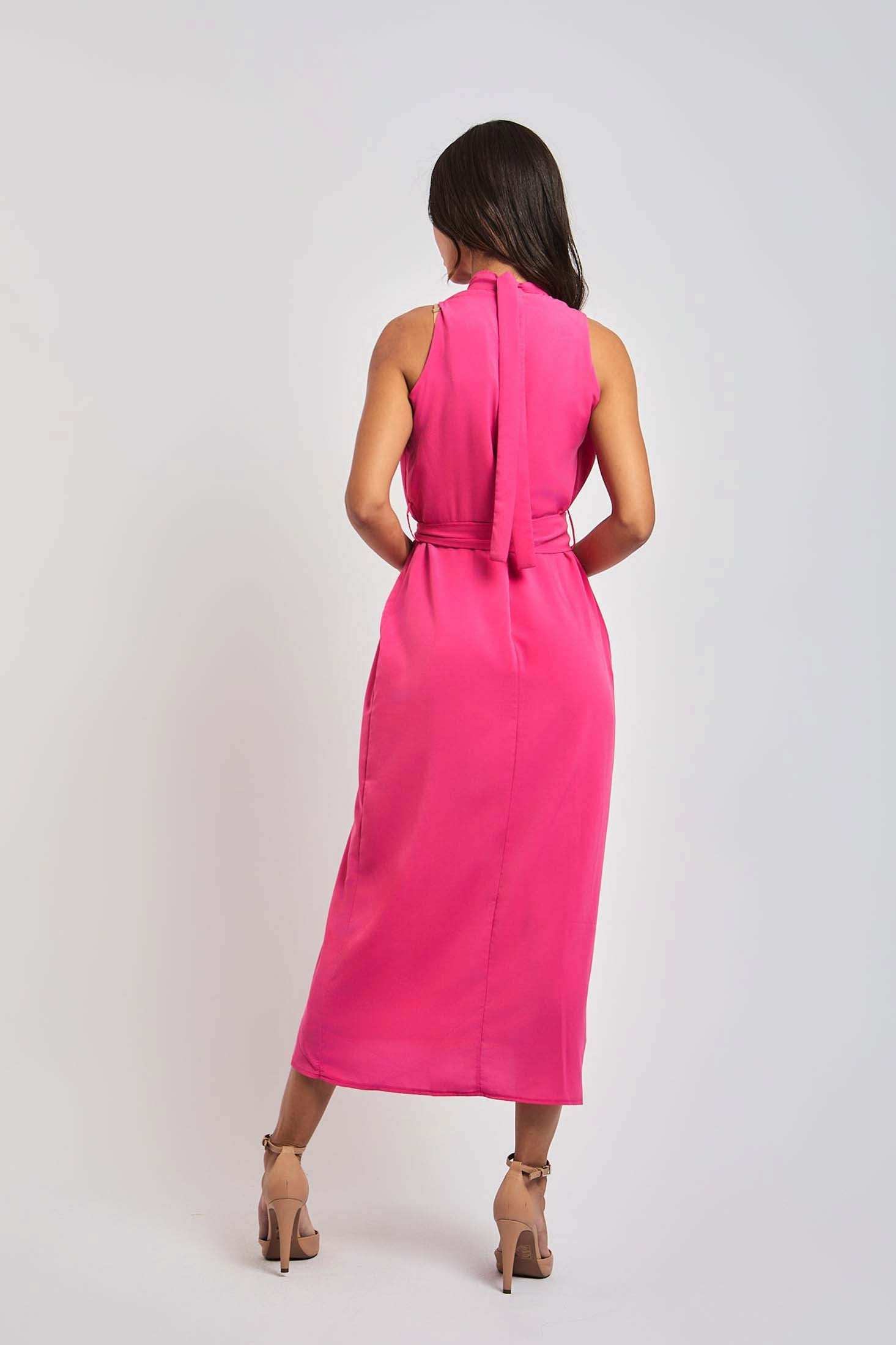 Woman in sleeveless pink midi dress from Dalydress, standing with back view