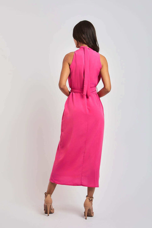 Woman in sleeveless pink midi dress from Dalydress, standing with back view
