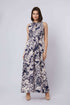 Woman in Dalydress sleeveless navy floral maxi dress, standing against light background