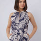 Woman in a Dalydress sleeveless dress with navy and cream abstract floral print